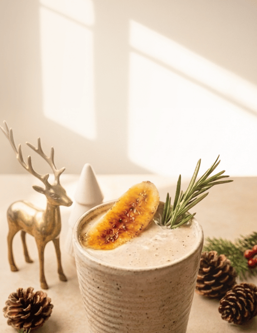 Toasted S'mores shake topped with toasted marshmallows, displayed with holiday décor.